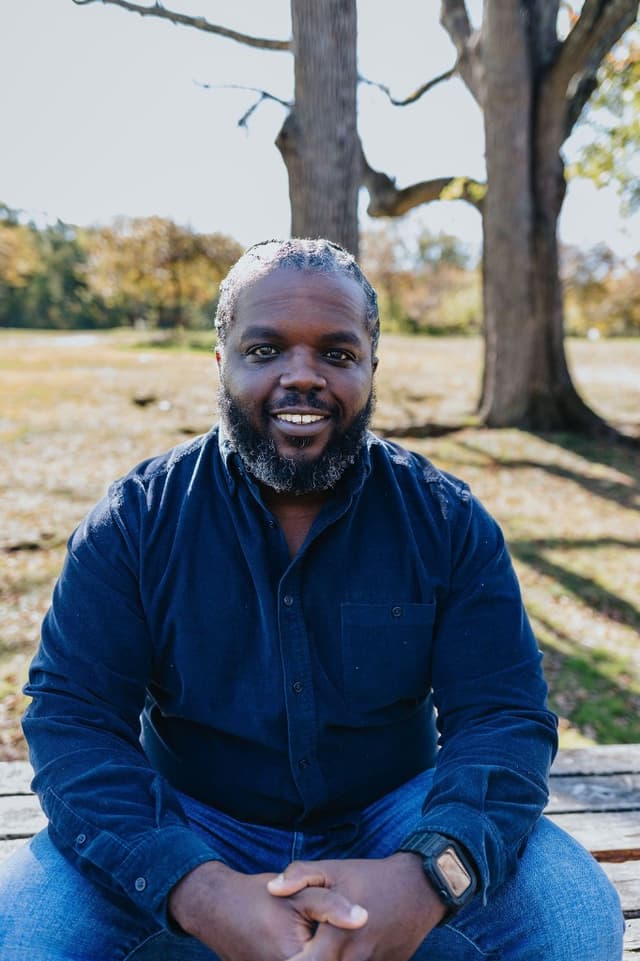 Valentine Rogers smiling outdoors in a park